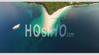 A Bird's-Eye-View Shows Boats Anchored By Zlatni Rat Beach On Brac Island, Croatia - Video Drone Footage