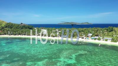 An Aerial View Shows Boats Docked On The Beach Of Yanuya Island, Fiji - Video Drone Footage