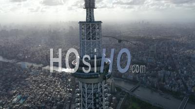 An Aerial View Highlights The Tokyo Skytree Towering Over Other Buildings In Tokyo, Japan - Video Drone Footage
