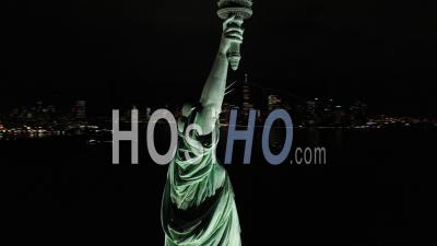 An Excellent Orbiting Aerial View Shows The Upper Half Of The Statue Of Liberty In New York City, New York At Night - Video Drone Footage