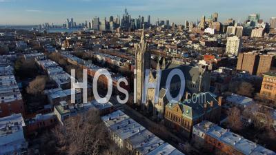 Excellent Aerial Of St. Agnes Catholic Church Brooklyn With Manhattan Skyline In Background - Video Drone Footage