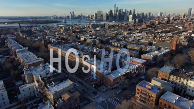Excellent Aerial Establishing Shot Of Brooklyn Apartments And Residential District With Manhattan New York City Skyline - Video Drone Footage