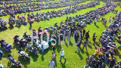 Good Aerial Over Bikers Arriving At A Huge Biker Rally In Ohio And Parking Motorcycles In Large Field - Video Drone Footage