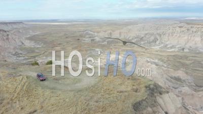 Person And Car On Edge Of Canyon, The Badlands, South Dakota, Usa - Video Drone Footage
