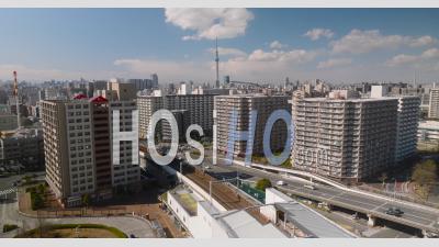 Train Passing By With Tokyo Skytree Visible - Video Drone Footage
