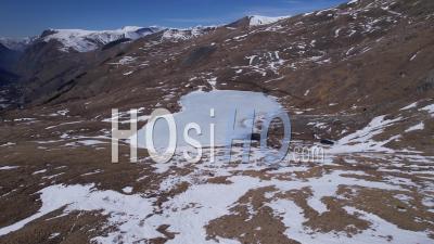 Frozen Mountain Lake (lac Du Pontet), Hautes-Alpes, France, Viewed From Drone