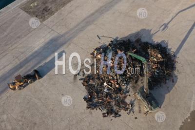 Recycling, Top View Of The Preparation Of A Mountain Of Steel And Scrap With Backhoe Loaders While Waiting For A Cargo Ship To Be Loaded In The Port, Martigues, Bouches-Du-Rhone, France - Aerial Photography