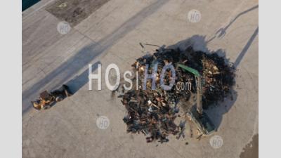 Recycling, Top View Of The Preparation Of A Mountain Of Steel And Scrap With Backhoe Loaders While Waiting For A Cargo Ship To Be Loaded In The Port, Martigues, Bouches-Du-Rhone, France - Aerial Photography