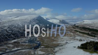 A9 Motorway And Loch Garry During Winter With Snow-Capped Mountains In The Background - Video Drone Footage