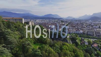 Aerial View Of Grenoble And Its Buildings Under The Chartreuse Massif In The French Alps - Video Drone Footage