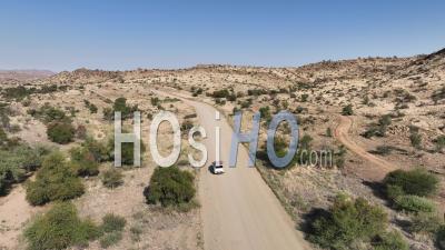 Four-Wheel Drive 4wd Car Driving On Desert Road D1275 Near Spreetshoogte Pass, Namibia - Video Drone Footage