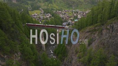 Train Crossing A Bridge In Switzerland, Daytime - Video Drone Footage
