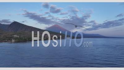 Sunrise Over Agung And Batur Volcanoes From Amed, Bali, Indonesia - Video Drone Footage