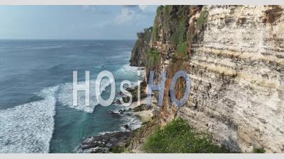 Seashore And Cliffs Nearby Pura Uluwatu Temple, Bali, Indonesia - Video Drone Footage