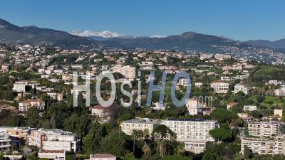Stunning Aerial Exploration Of Nice, France Showcasing Mountains And Lush Residential Areas - Video Drone Footage